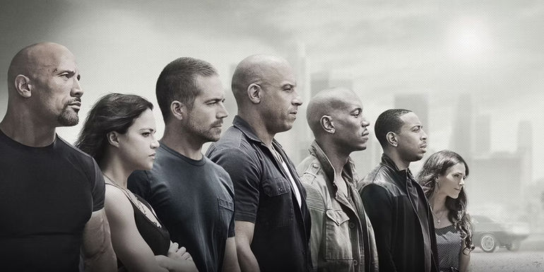The main cast of Furious 7 lined up and facing in the same direction in a cropped version of the movie poster
