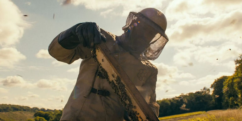 Jason Statham as Clay from The Beekeeper in a beekeeper suit