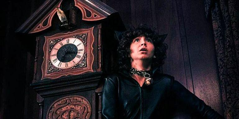 James stands in front of a clock in costume in Goosebumps episode 3
