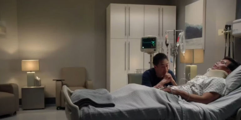 Chimney (Kenneth Choi) sitting at Albert Han's (John Harlan Kim) bedside while Albert's in a coma in 911.