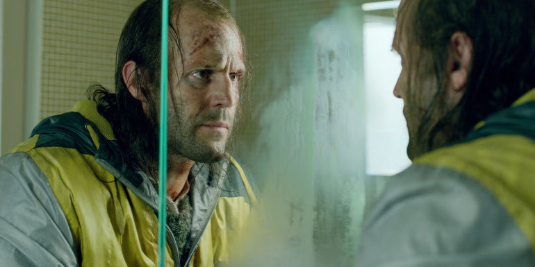 Jason Statham looking in the mirror with blood on his face in Redemption-1