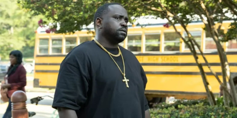 Al (Brian Tyree Henry) by a school bus in Atlanta
