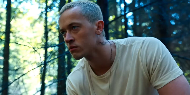 Tom Blyth as Coriolanus Snow looking pensive in a white T-Shirt in The Hunger Games The Ballad of Songbirds and Snakes