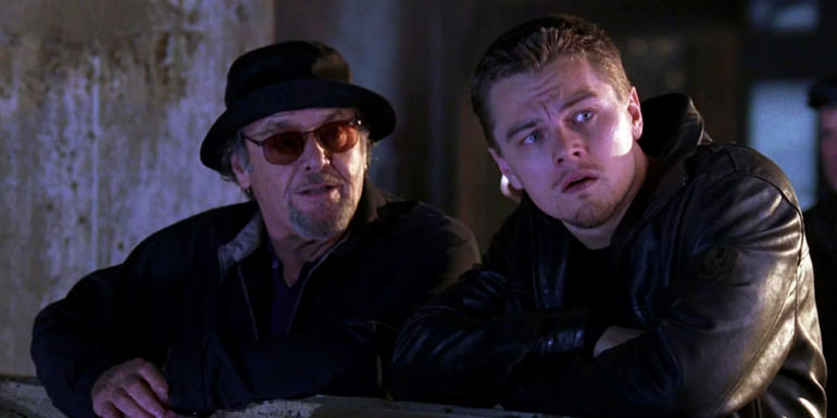 Frank Costello and Billy Costigan Jr. leaning on a rail and looking off in the distance in The Departed.
