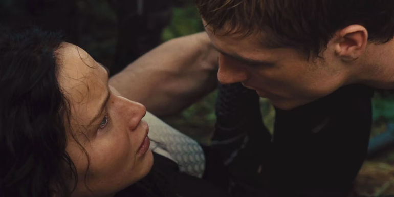 Katniss and Peeta look worried after Peeta is hit by the forcefield