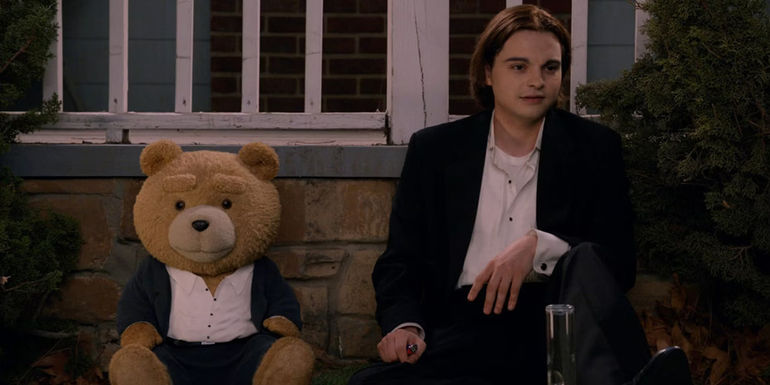 Ted and John sitting on the lawn in Ted