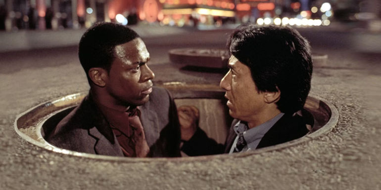 Lee (Jackie Chan) and Carter (Chris Tucker) emerging from a sewer in Rush Hour 2