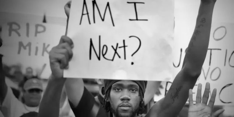 A man protesting in 13th