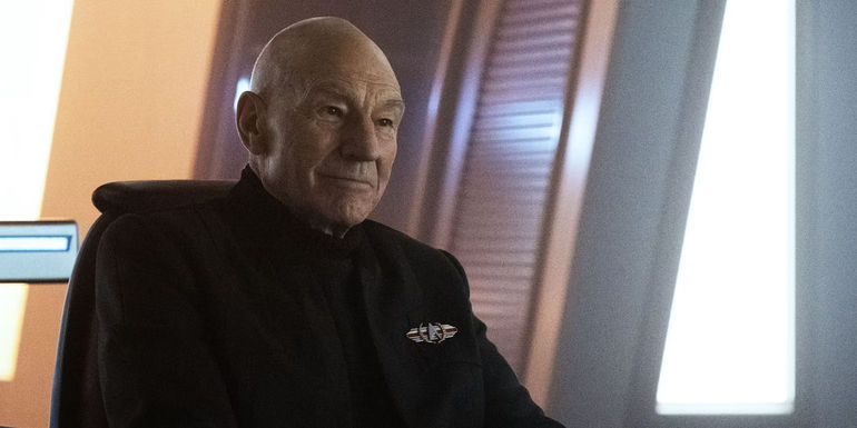 Admiral Picard, out of uniform and seated