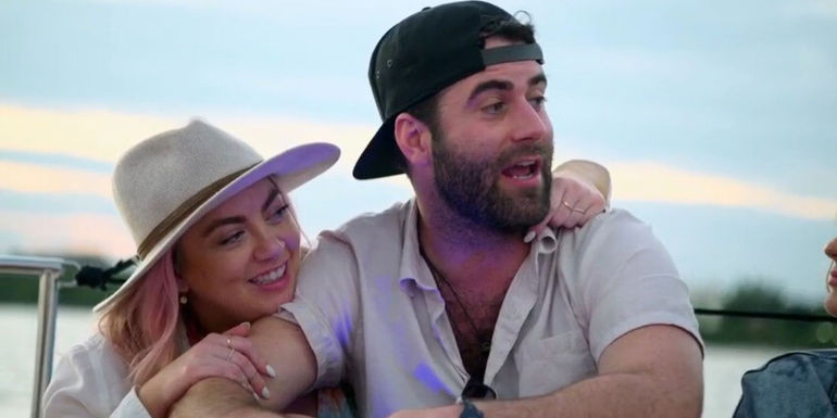 Becca and Austin from MArried at First Sight season 17 sitting on a boat talking 