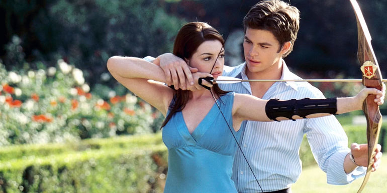 Nicholas (Chris Pine) teaching Mia (Anne Hathaway) how to shoot a bow and arrow in The Princess Diaries 2