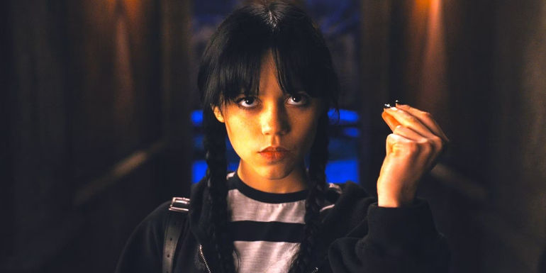 Wednesday (Jenna Ortega) looking upward and snapping her fingers in Netflix's Wednesday season 1