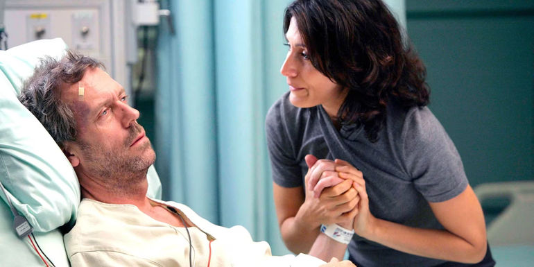 House Lying in a Hospital Bed with Dr. Lisa Cuddy by His Side in House, M.D.