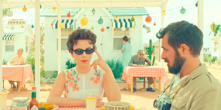 Scarlett Johansson and Jason Schwartzmann at a table in Asteroid City