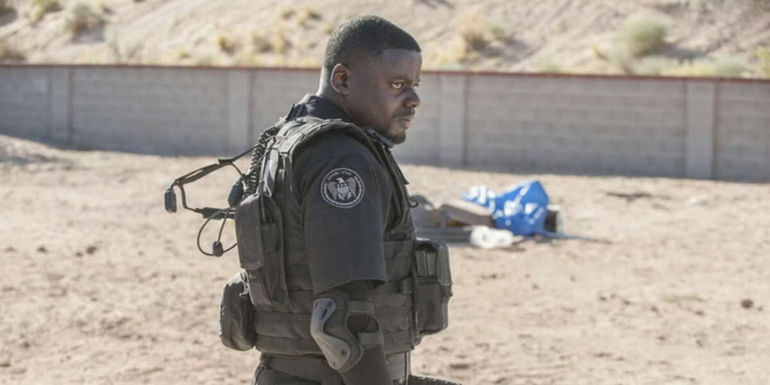 Reggie Wayne (Daniel Kaluuya) standing in uniform in Sicario.