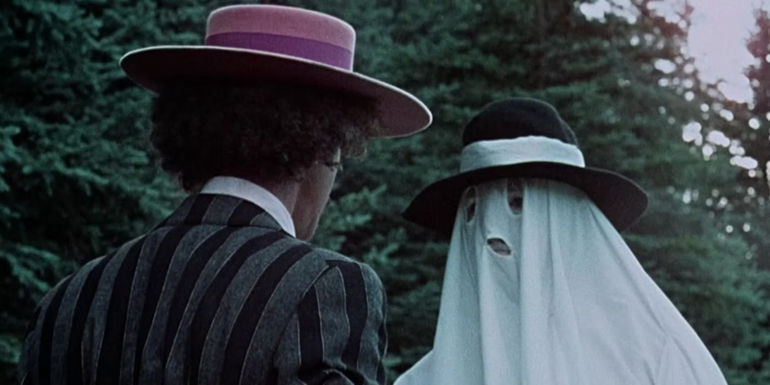 Allan Arbus's Jesse talks to someone wearing a sheet in Greaser's Palace