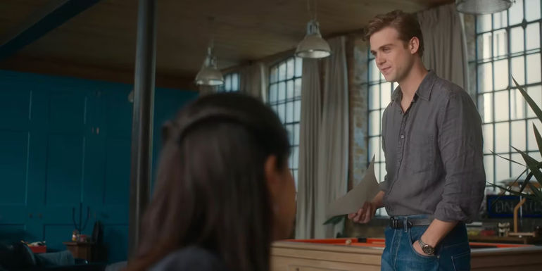 Dexter holding a paper and smirking. 