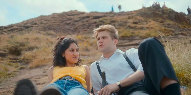 Emma and Dexter lying down on Arthur's Seat. 