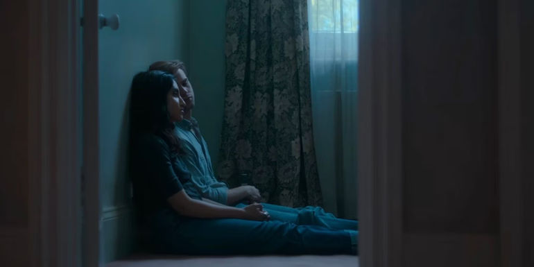 Emma and Dexter sitting on the floor together.