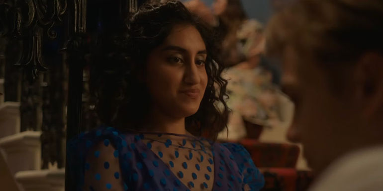 Emma sitting on the stairs, smiling down at Dexter. 