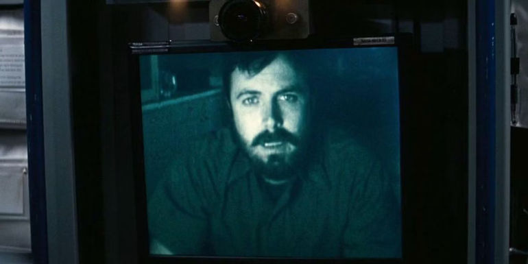 Tom (Casey Affleck) calling on a video screen in Interstellar.