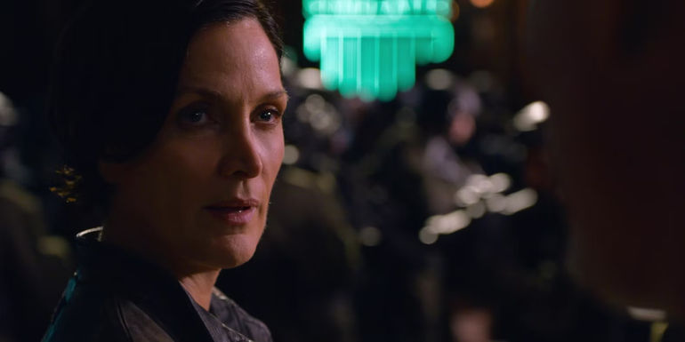Carrie Anne Moss as Trinity in a club in The Matrix Resurrections