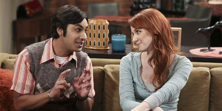 Emily and Raj talking to each other on his couch