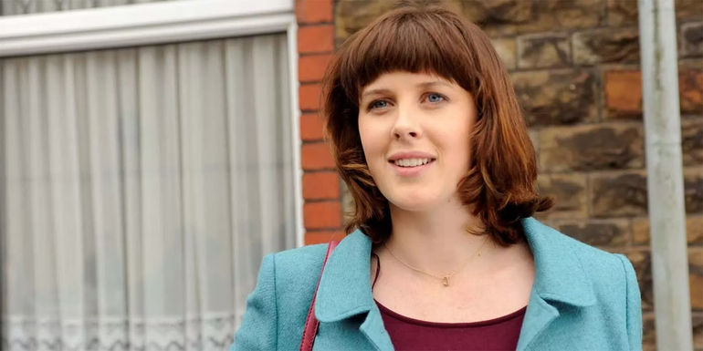Alexander Roach smiling while in front of a house