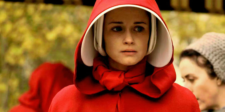 An image of Emily wearing her handmaiden uniform in The Handmaid's Tale
