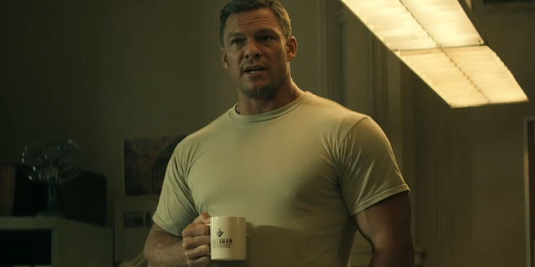 Alan Ritchson drinking coffee as Reacher