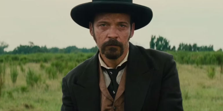 Bartholomew Bogue (Peter Sarsgaard) in a field in The Magnificent Seven