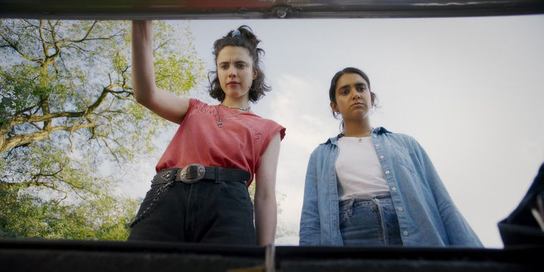 Jamie and Marian open the trunk of their car in Drive-Away Dolls