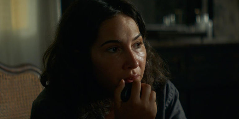 Jackie Cruz's Alegre using a radio in History of Evil