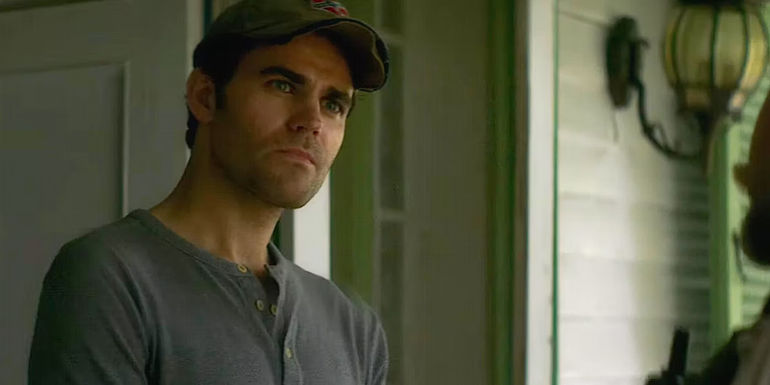 Paul Wesley stands outside a house in History of Evil