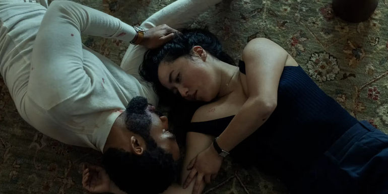 John (Donald Glover) and Jane (Maya Erskine) looking into each other's eyes while laying on the floor in Mr. & Mrs. Smith's finale - Posey’s Jane & Moura’s John take over as protagonists - Erskine’s Jane & Glover’s John Are Killed By Posey’s Jane