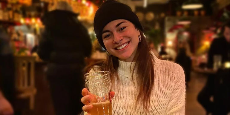 Below Deck Marie Marquis Instagram Post where she is holding a beer and smiling - Sunny Marquis's Age