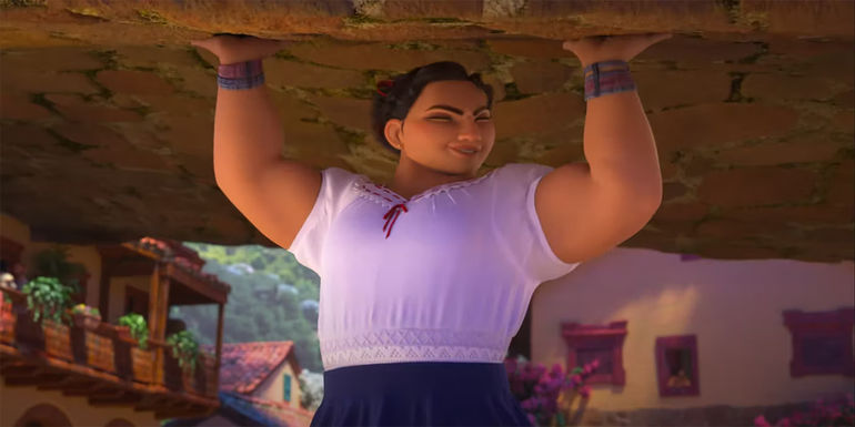 Luisa holds a rock over her head in Disney's Encanto. - Voiced by Jessica Darrow - Luisa: Super Strong