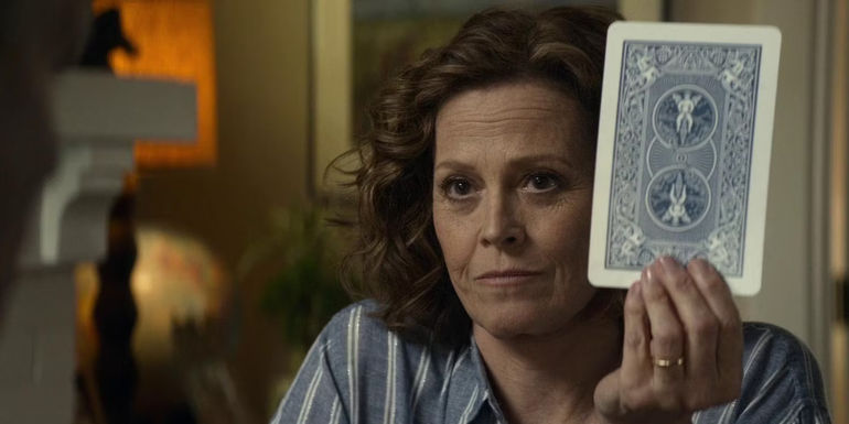 Sigourney Weaver with a tarot card in Ghostbusters Afterlife - Ghostbusters: Afterlife Revealed Peter Venkman Is Married To Dana Barrett