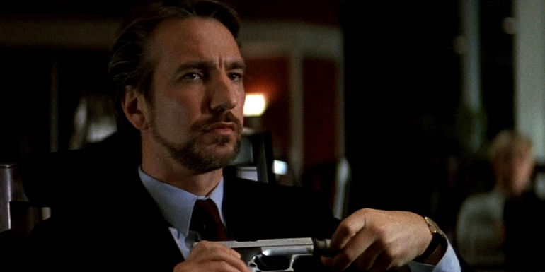 Hans Gruber taking the silencer off his gun in Die Hard
