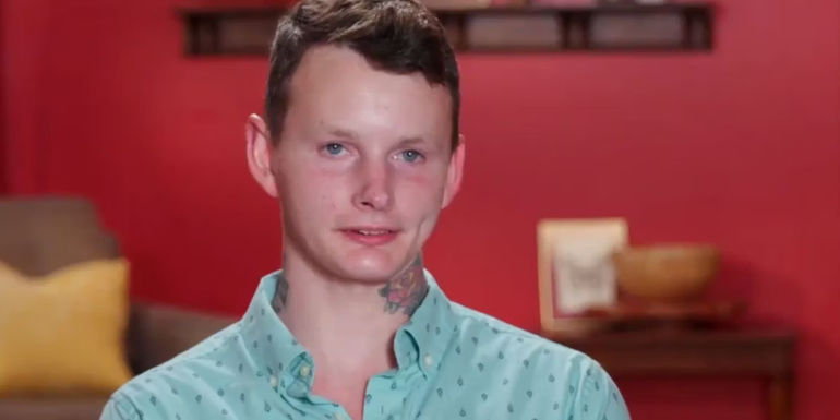 Sam in 90DayFiance wearing blue shirtduring interview