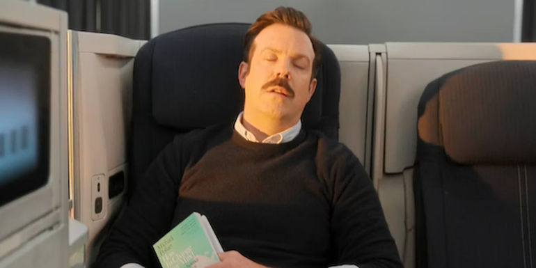 Ted Lasso sleeping on a plane in the Ted Lasso season 3 finale