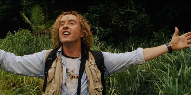 Damien with arms spread wide in Tropic Thunder.