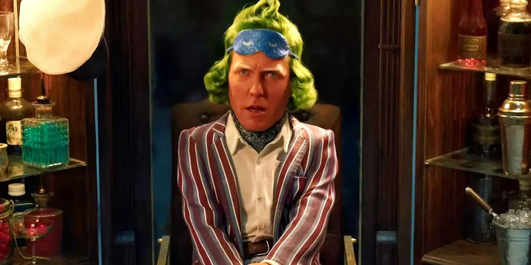 Hugh Grant as an Oompa-Loompa wearing a sleep mask in Wonka