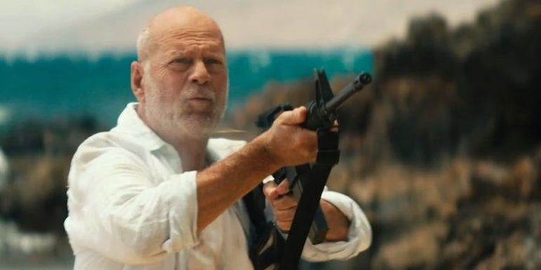 Bruce Willis as Ian Swan pointing a machine gun in Paradise City