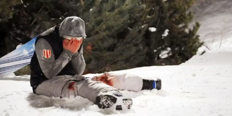 Joe (Shawn Ashmore) with fractured legs in the snow in Frozen