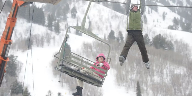 Dan (Kevin Zegers) climbs along the ski lift cables in Frozen