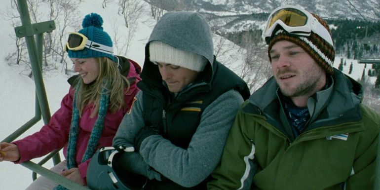 Dan (Kevin Zeger), Joe (Shawn Ashmore), and Parker (Emma Bell) smiling on the ski lift in Frozen