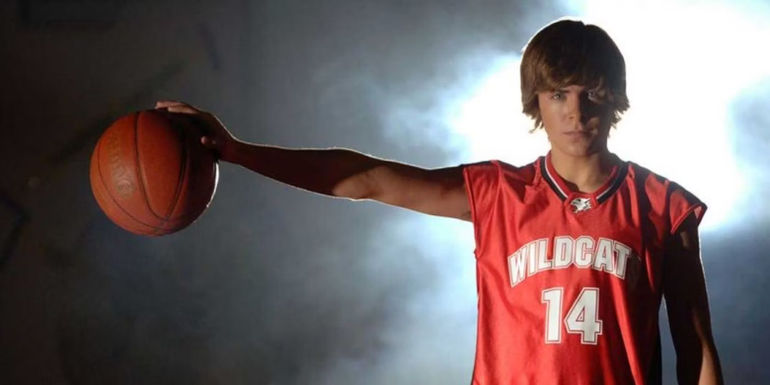 Troy Bolton (Zac Efron) holding a basketball in High School Musical.
