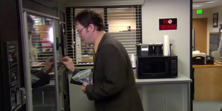 Rainn Wilson as Dwight Schrute getting his desk supplies out of the vending machine in The Office