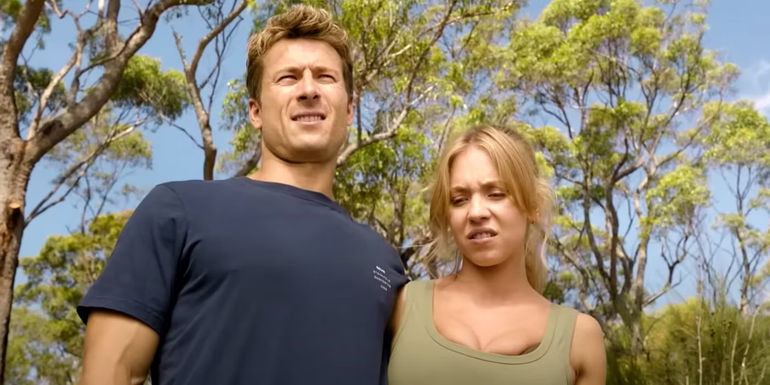 Glen Powell and Sydney Sweeney with their arms around each others backs in Anyone but You